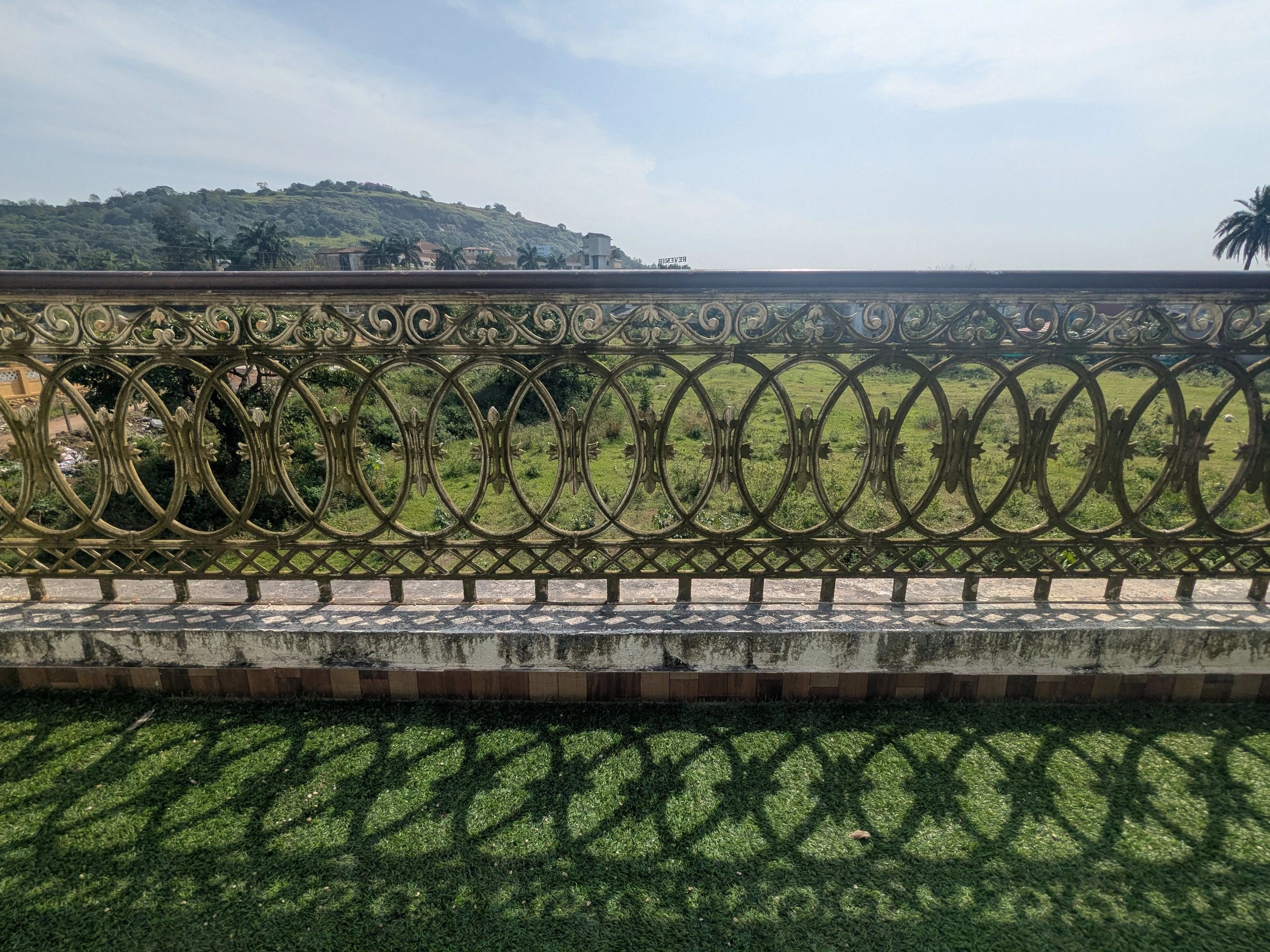 View from a balcony overlooking a green field